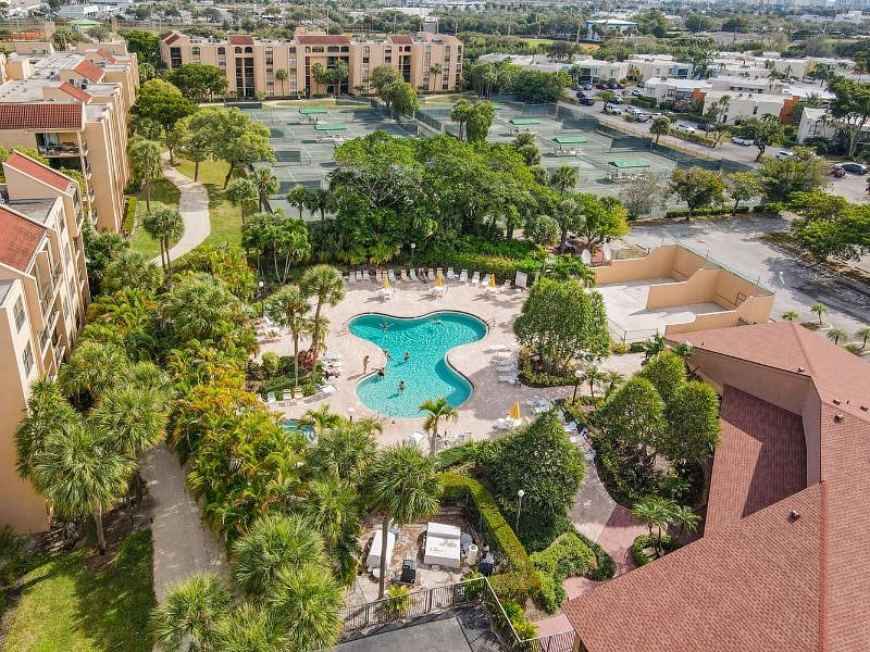 Drone view of one of the pools and clay tennis courts at the Delray Beach Racquet Club