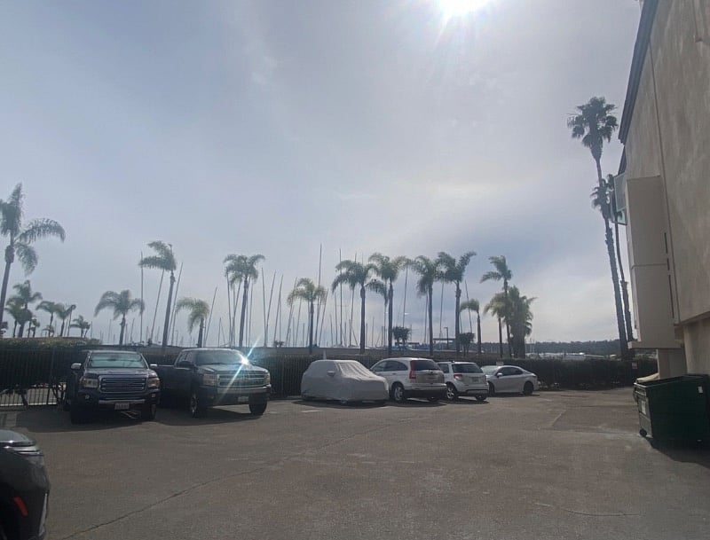 Space next to covered car is the assigned parking space