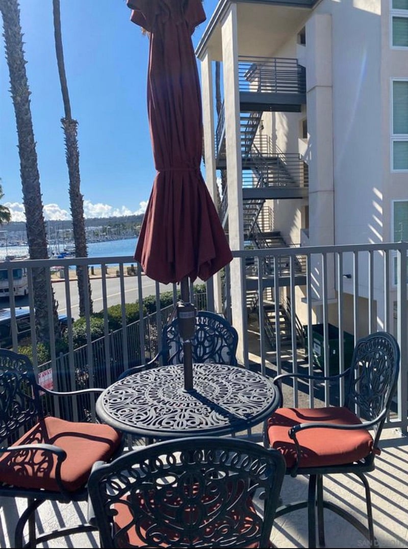 One of several patio tables by the pool with water view