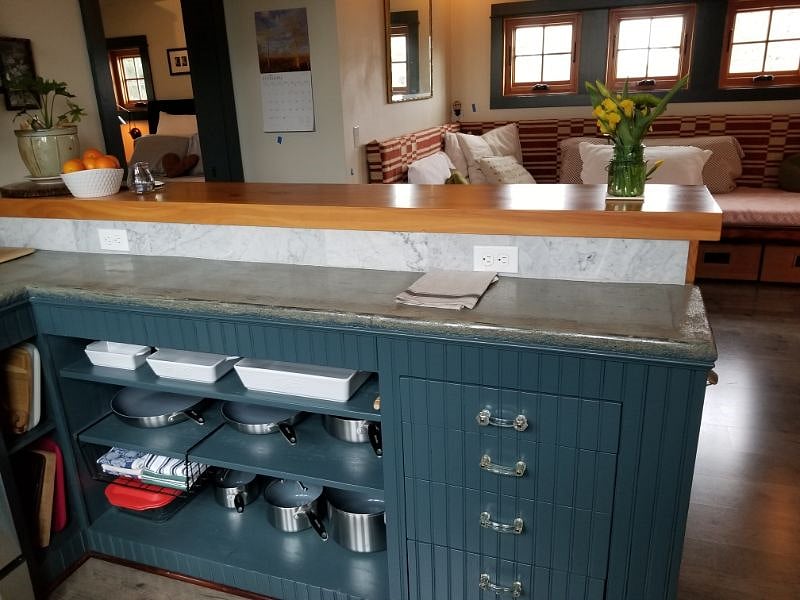 Drop-counter keeps kitchen work out-of-view from living room and separates dining bar from workspace.