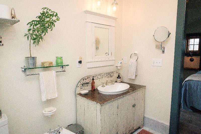 The medicine cabinet is fitted with an outlet for your electric toothbrush, and the wall mirror has one magnified side, for plucking.