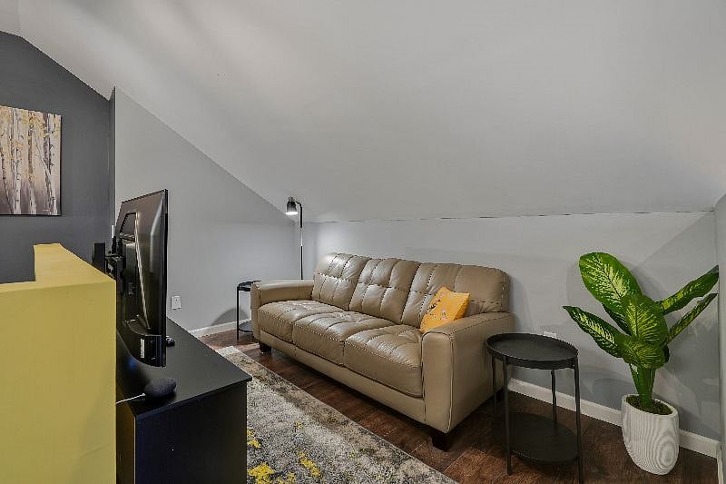 Lounge in the loft space includes full size leather couch and 55" 4K smart TV