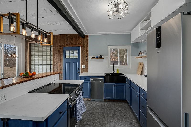 Fully stocked kitchen with dishwasher, electric stove, microwave, cooking and baking ware