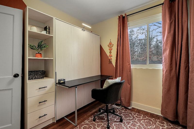 Office by day, this convertible space includes white board, office supplies, and safe