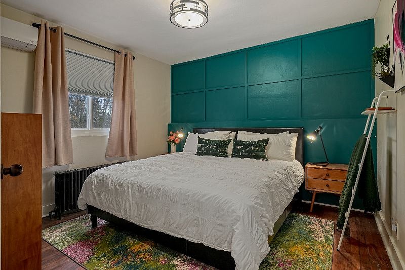 This large bedroom offers a king-size bed, blackout shades, A/C and 55" 4k smart TV