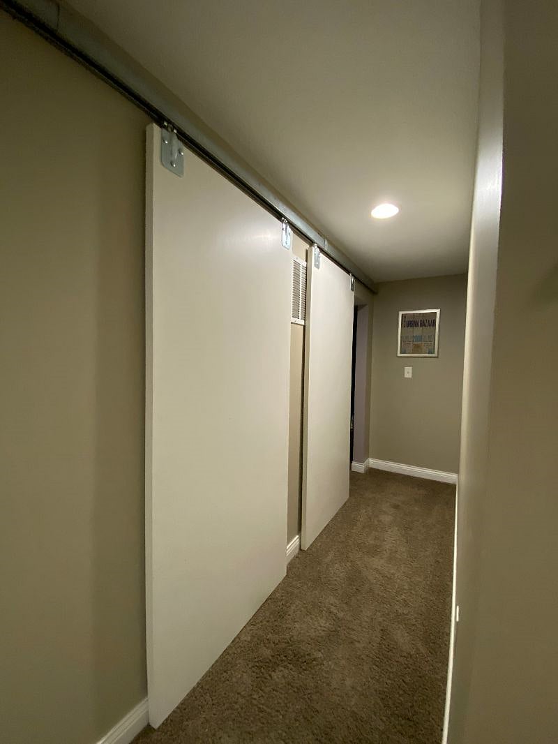 Basement hallway to bedroom and storage room
