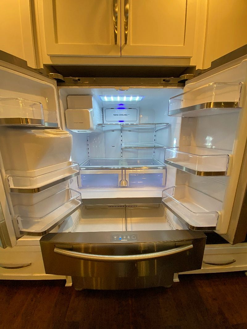 Kitchen fridge has pull out drawer and freezer on the bottom