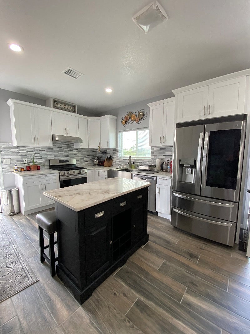 Kitchen cabinets, refrigerator, utensils, pots/pans and kitchen island.