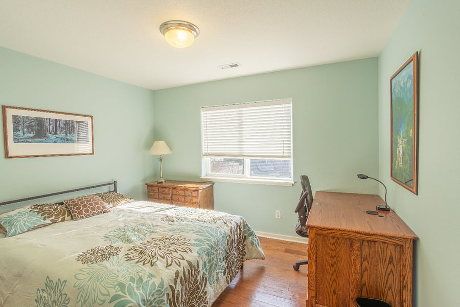 bedroom #2 with queen bed, desk, & dresser