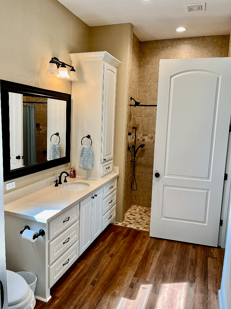 Large bathroom, lots of cabinets and drawers, full-sized shower with double shower heads.