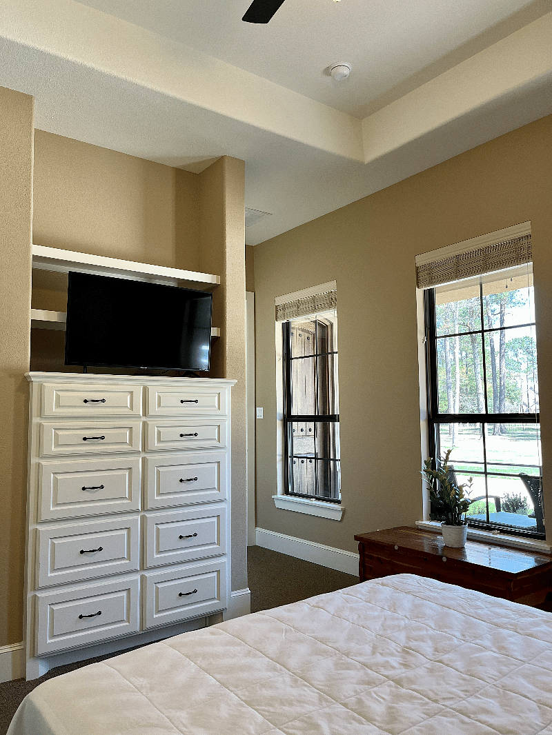 Primary bedroom, large closet with lots of space for clothes, etc. Built-in dresser, tv in room, ceiling fan.