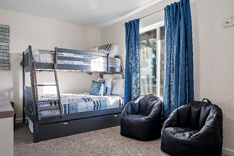 Third bedroom with bunkbed that provides a full bottom bed, a twin top bed, and a twin trundle bed.