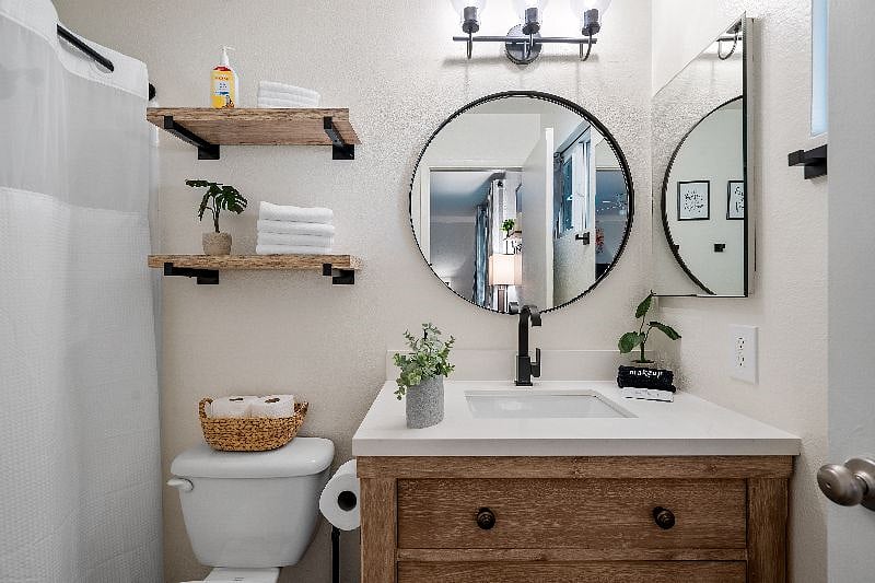 Primary en suite bathroom with step-in shower and starter supplies to get you through your first few days settling into