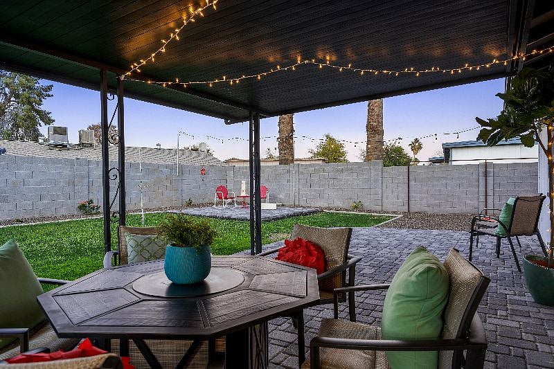 The backyard has so much for your enjoyment, including covered patio with propane fire table