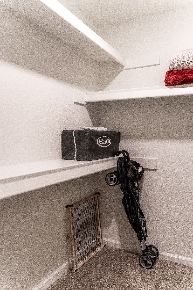 Primary bedroom walk in closet where you'll find many amenities