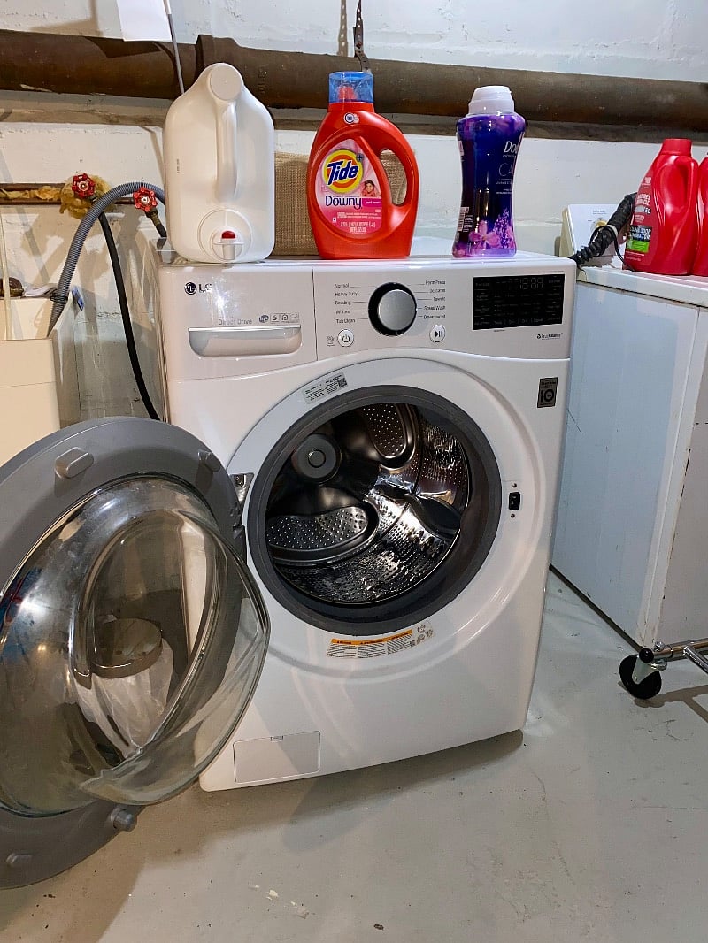 Washer and laundry setup in basement. Laundry supplies included.