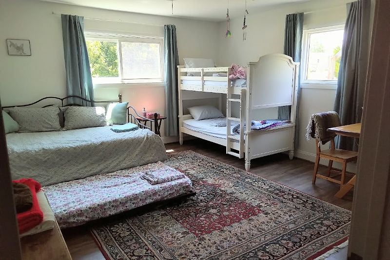 Bedroom with full bed (and pullout lower trundle) plus two bunk beds