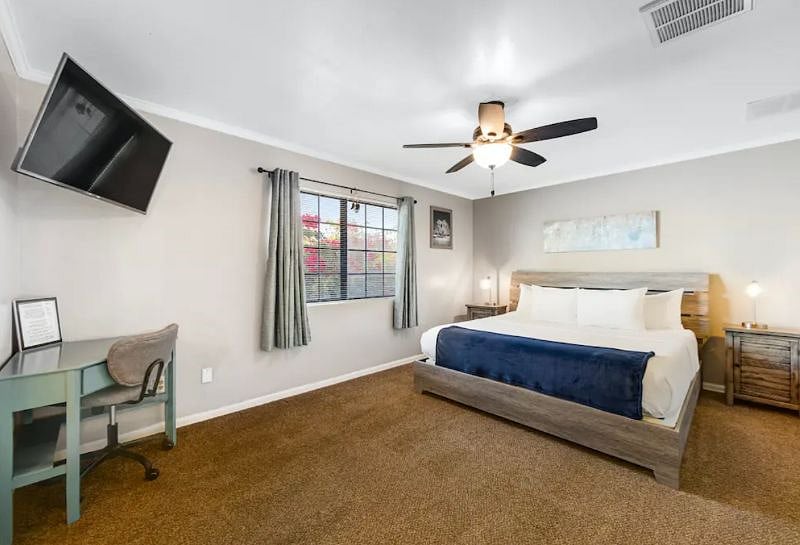 Primary bedroom with king bed and Roku TV and desk area