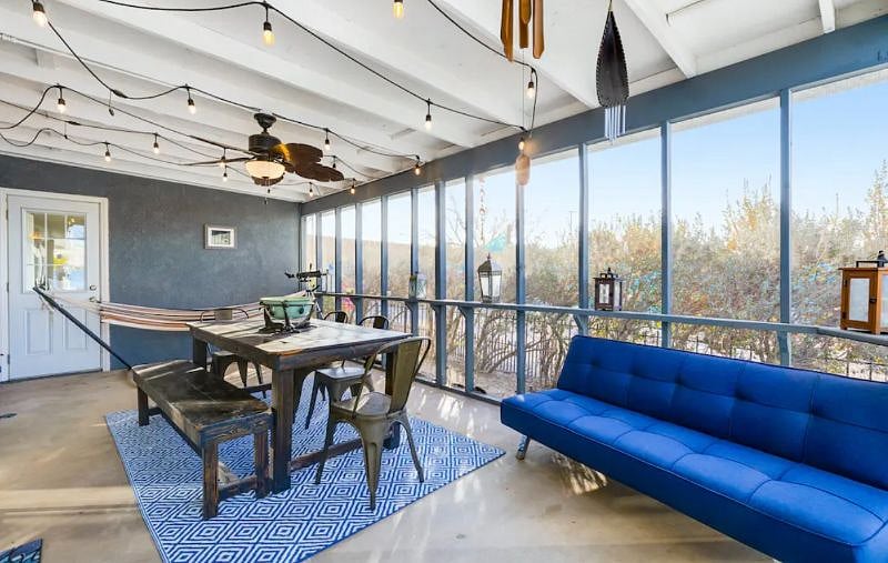 Enclosed patio with dining area, hammock and telescope