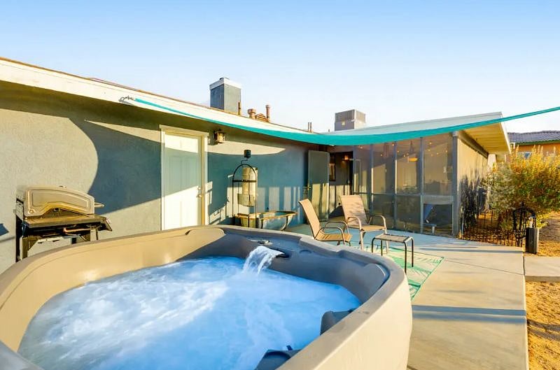 Fully fenced backyard with patio area, hot tub & grill