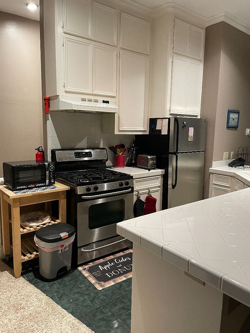 Fully stocked kitchen (BYO food) with a range/oven, microwave, dish washer, and full sized fridge