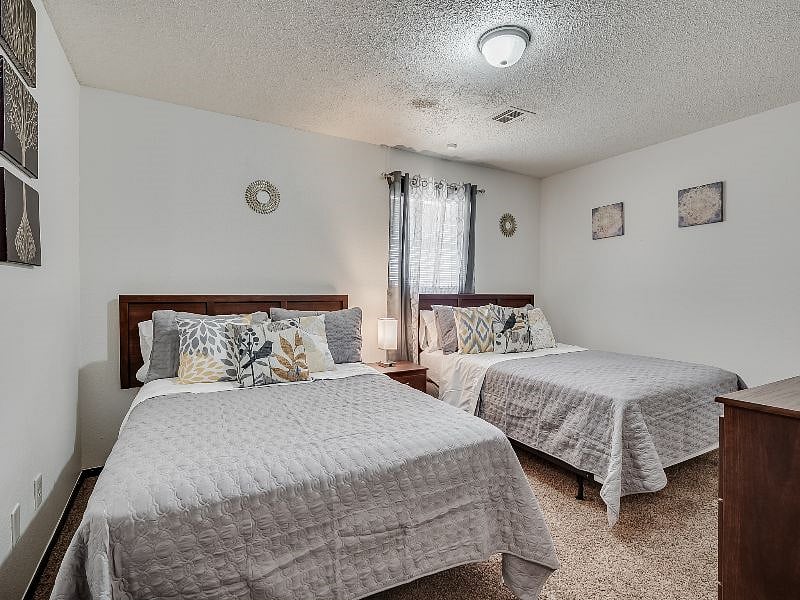 Bedroom #2 with 2 full size beds, smart TV (installed after photos) chest of drawers and large closet.