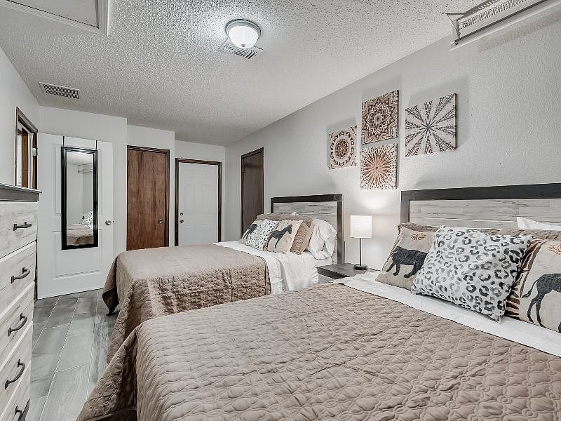 Bedroom #3 with 2 full size beds, smart TV (installed after photos) chest of drawers and large closet.