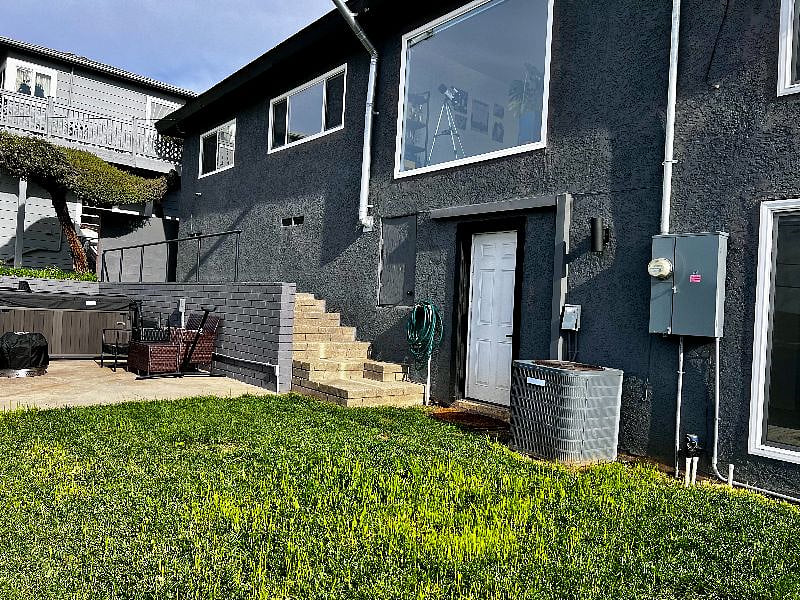 Photo is of the back of the house, the stairs lead to the side entrance that residents will use to access the studio. The top unit pictured is where we reside