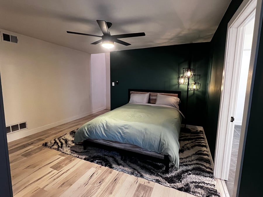 Stairs behind the bedroom wall leads to shared washer and dryer in the garage.