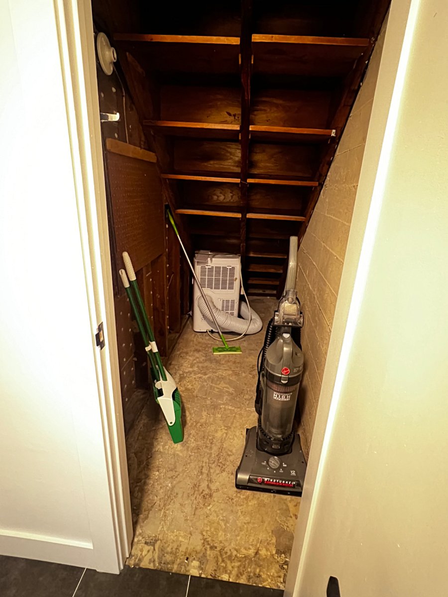 Under stairs storage space, vaccum, broom, and swiffer included for use in the studio. 