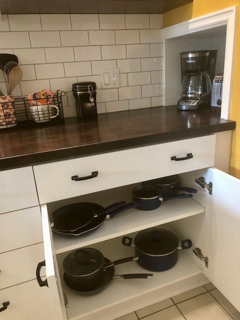 Kitchen cupboard w/pots and pans