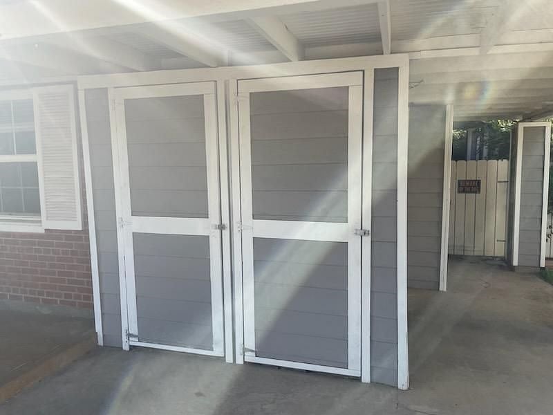 Large storage area for boxes, travel totes or bicycle! You supply your own locks!