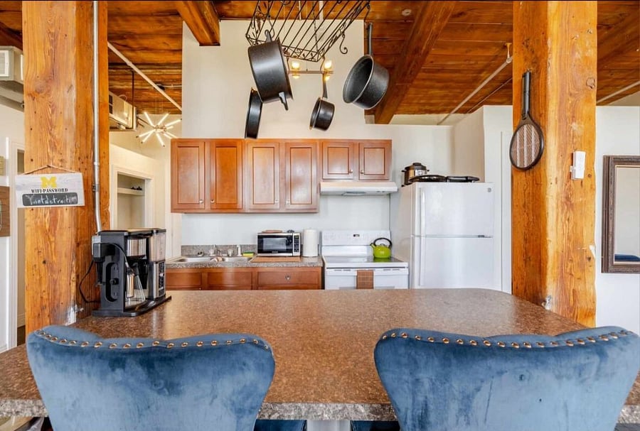 Kitchen with Coffee maker, Microwave, stobve and oven, and full refrigerator.