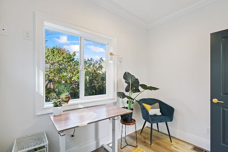 Office with adjustable height desk and swivel chair
