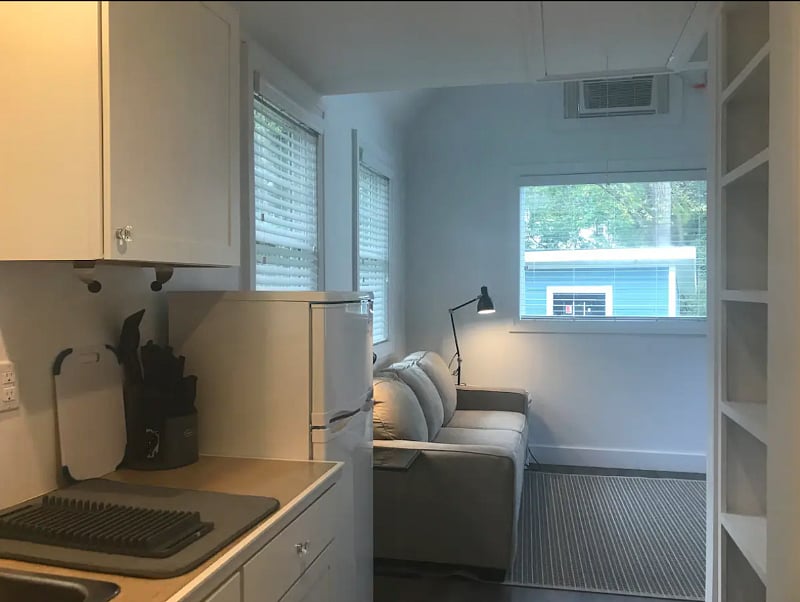 View into living room from kitchen. Couch pulls out into Queen bed.