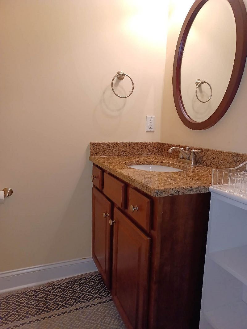 Granite counter with storage in bathroom.
