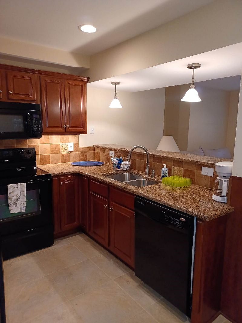 Full size kitchen with granite counters, full size dishwasher, built in microwave, full size range and ample storage..


