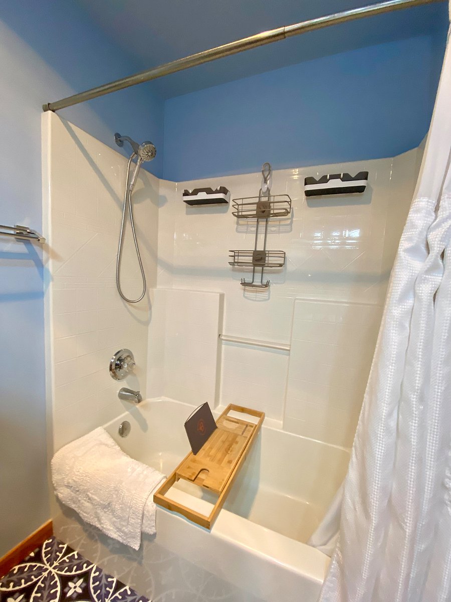 Guest en Suite with bath tub, extra storage, and tray for a relaxing soak after a long day.