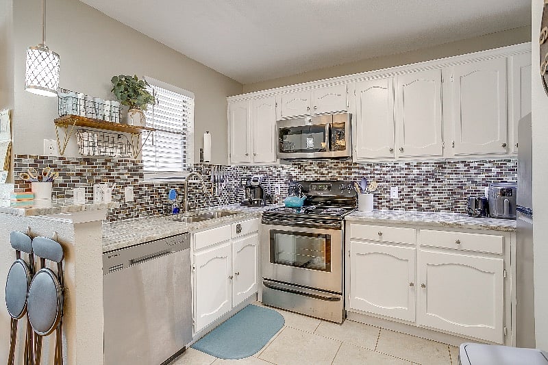 Fully stocked kitchen with stainless steal appliances.