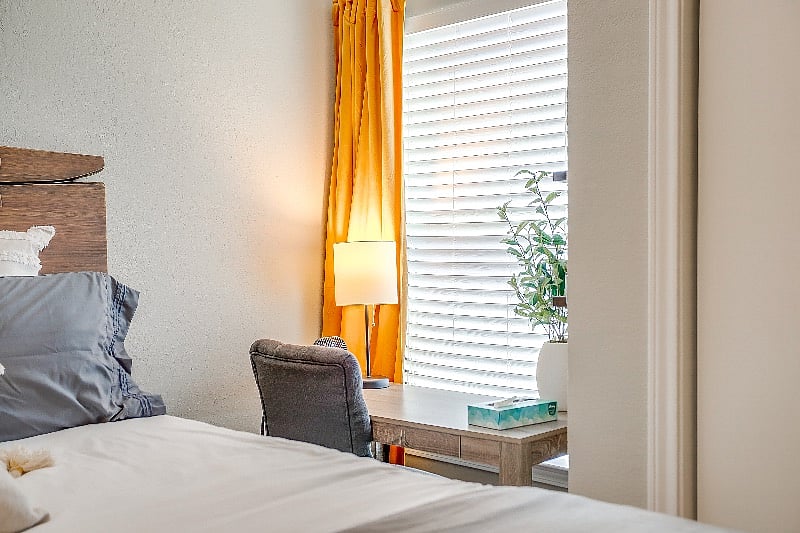 All windows have black out curtain liners. Extra space in the main level bedroom to use for workspace or vanity.