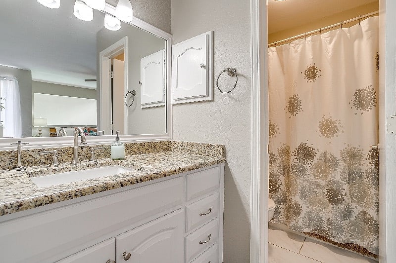 Unique bathroom provides private area for toilet and shower.