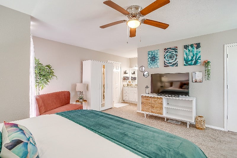 Pretty and open upper level loft bedroom with king bed and seating area.