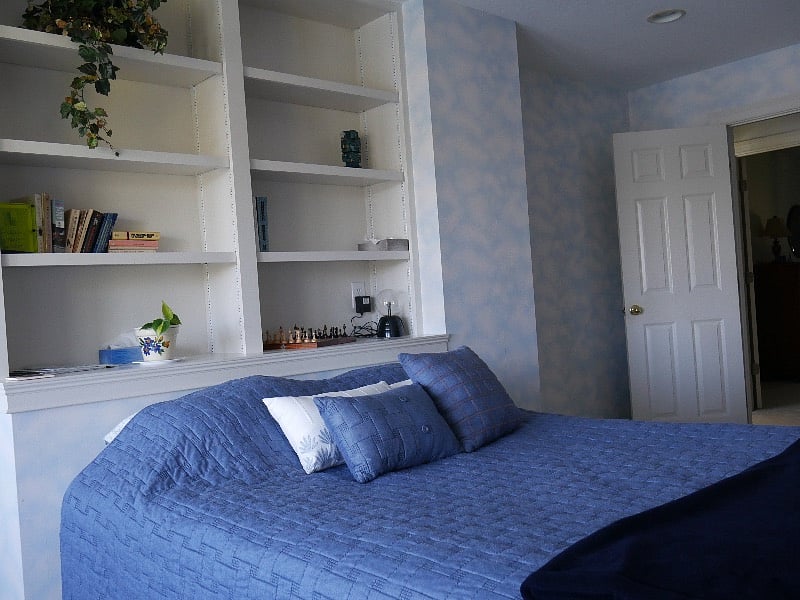 Bed Rm bed and bookshelves 
