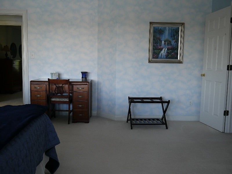 bedroom desk, closet entrance and exit to hallway