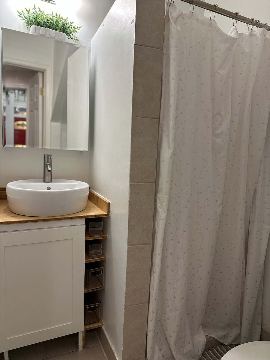 Step into a cozy bathroom designed for your comfort, where you can enjoy a refreshing shower and easily store all your personal products.