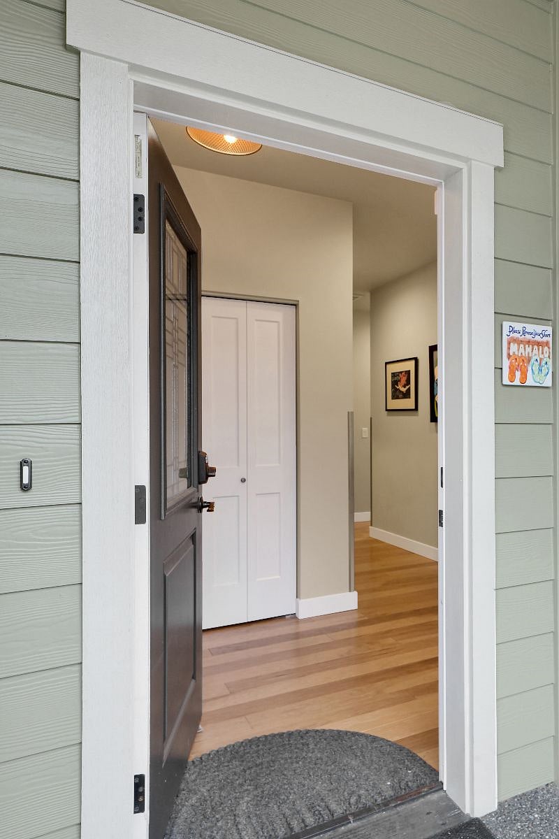 Foyer entrance with storage closet and hangers.