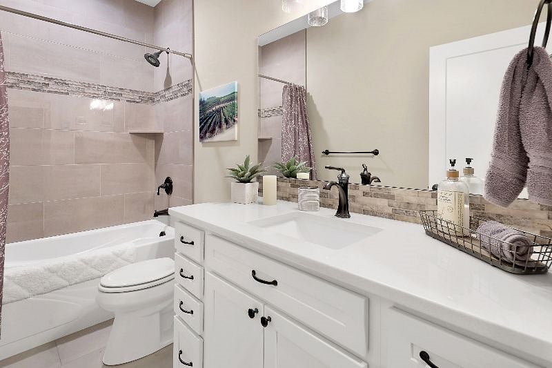 Stylish bathroom with quartz countertops.