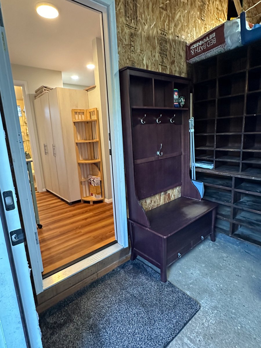 Private entrance through garage, with area for shoes, coats and other items.