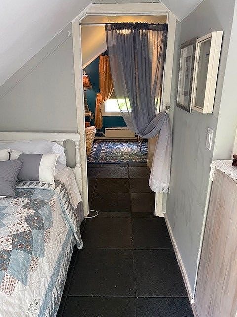 Attention: This additional room is not included in base rent. It is available for additional rental.
View from bedroom, rear, to living area, front.