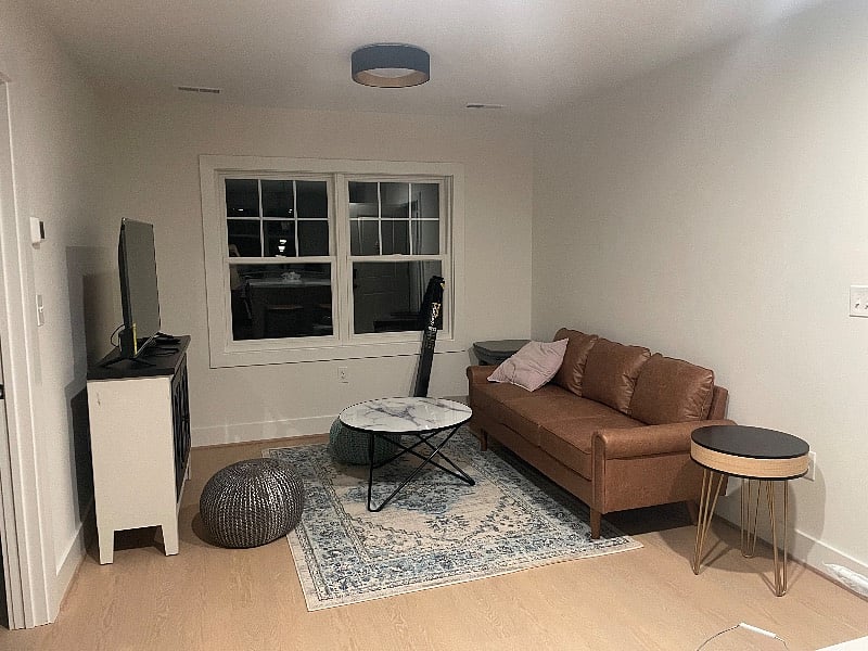 Spacious living room with 55 inch tv smart tv for streaming.  Couch and chair to come for seating. 